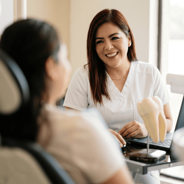 Dentist consulting patient about wisdom tooth removal in Mazatlan clinic.